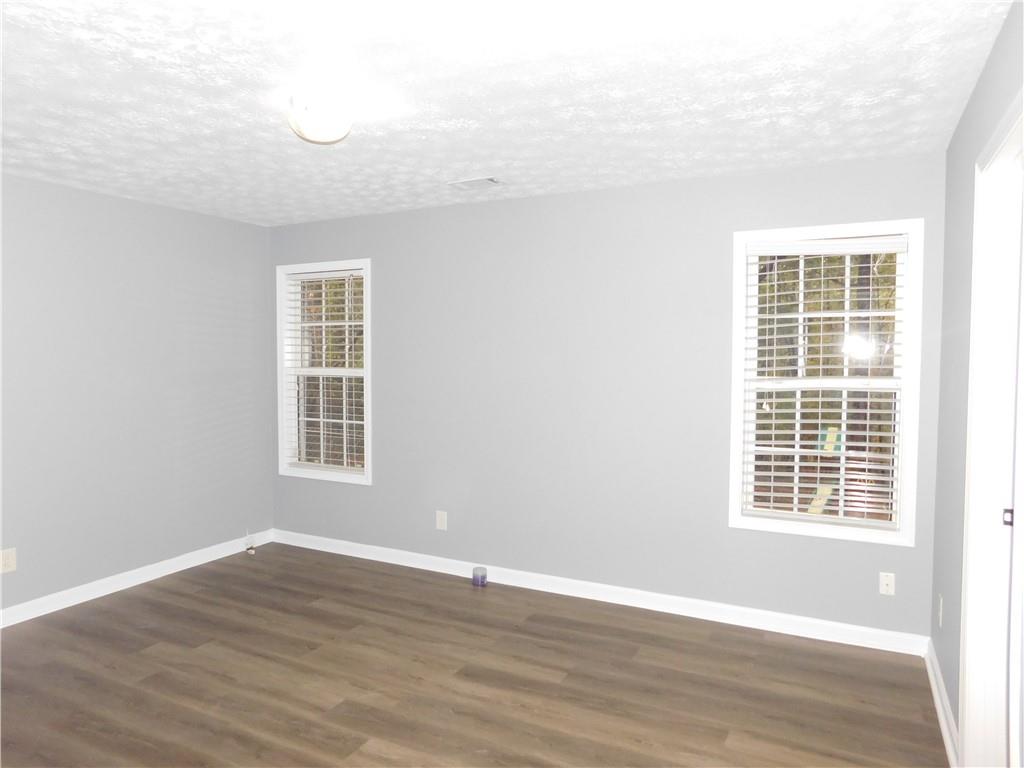 2614 Carolina Court Bethlehem, GA 30620 - Photo 25 of 42 a view of an empty room with wooden floor and a window
