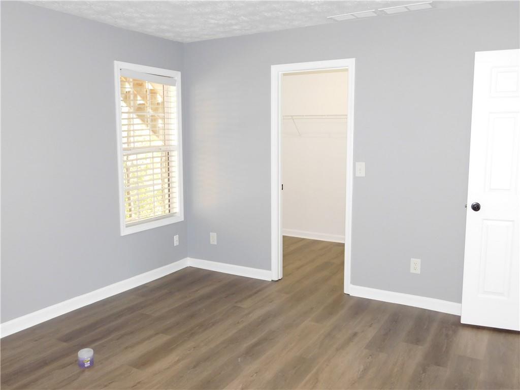 2614 Carolina Court Bethlehem, GA 30620 - Photo 26 of 42 an empty room with wooden floor and windows