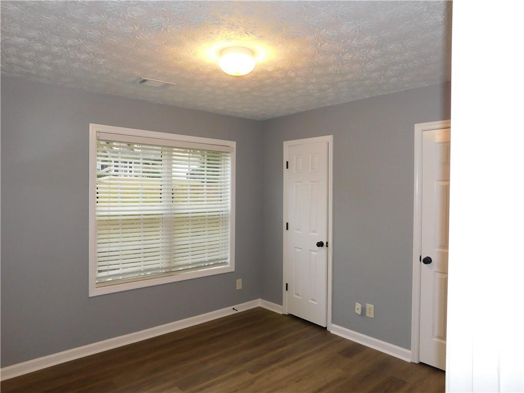 2614 Carolina Court Bethlehem, GA 30620 - Photo 27 of 42 a view of an empty room with wooden floor and a window