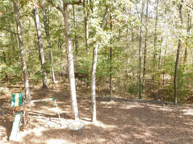 a view of a yard and trees