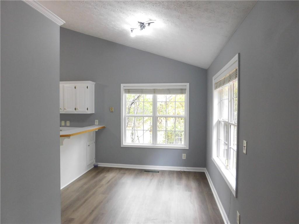 2614 Carolina Court Bethlehem, GA 30620 - Photo 6 of 42 a view of an empty room with a window and wooden floor