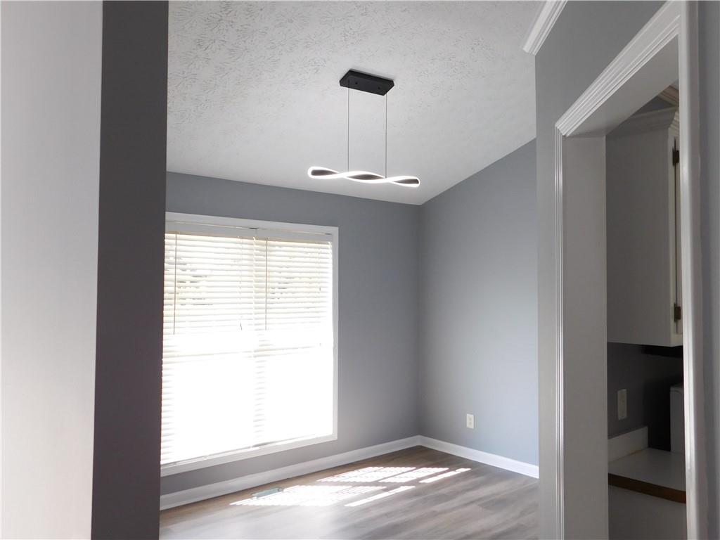 2614 Carolina Court Bethlehem, GA 30620 - Photo 7 of 42 a view of empty room with window and wooden floor
