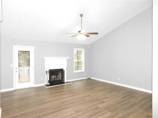 a view of livingroom with fireplace wooden floor and window