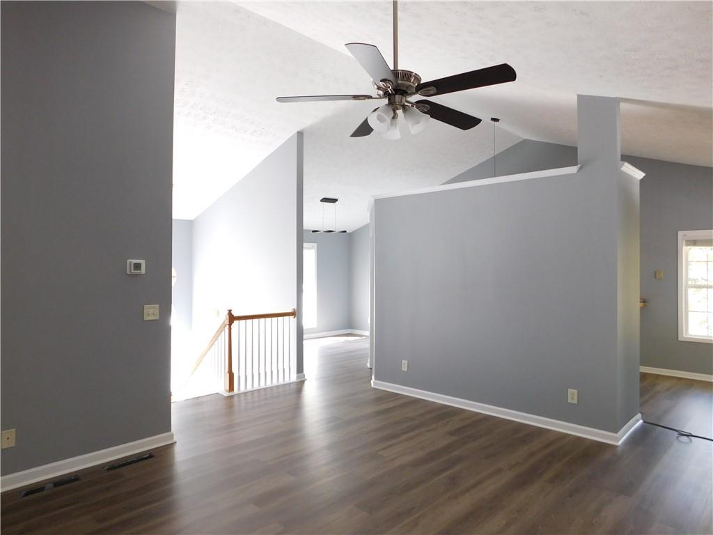 2614 Carolina Court Bethlehem, GA 30620 - Photo 10 of 42 an empty room with wooden floor fan and windows