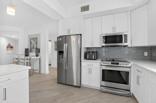 a kitchen with a stove microwave and refrigerator