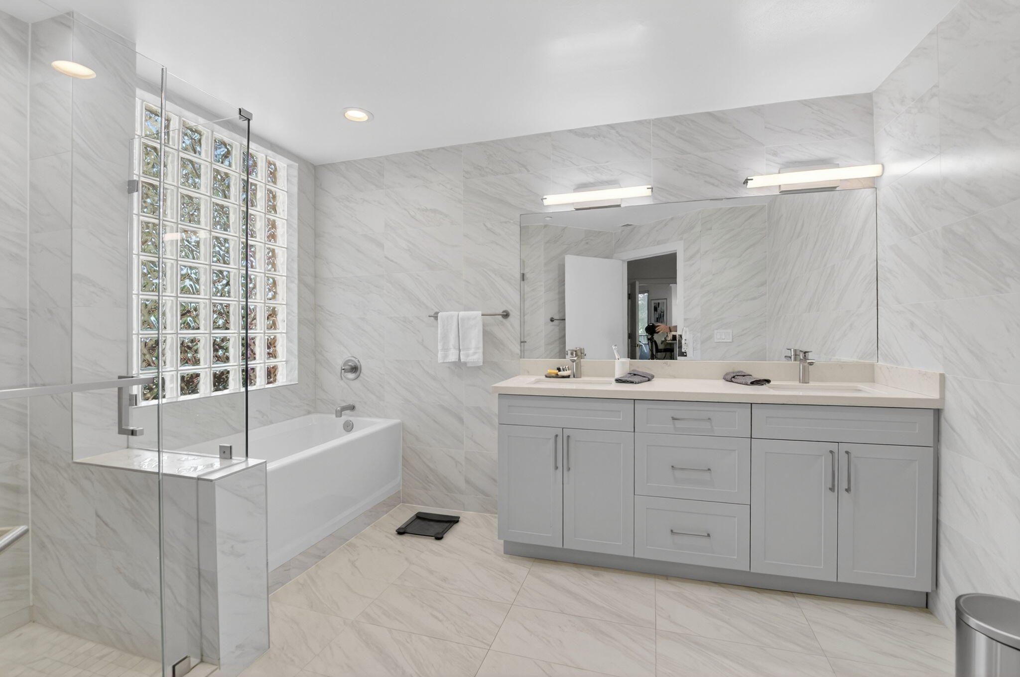 7546 La Paz Boulevard, Unit 205 Boca Raton, FL 33433 - Photo 17 of 33 a spacious bathroom with a double vanity sink a mirror and a bathtub