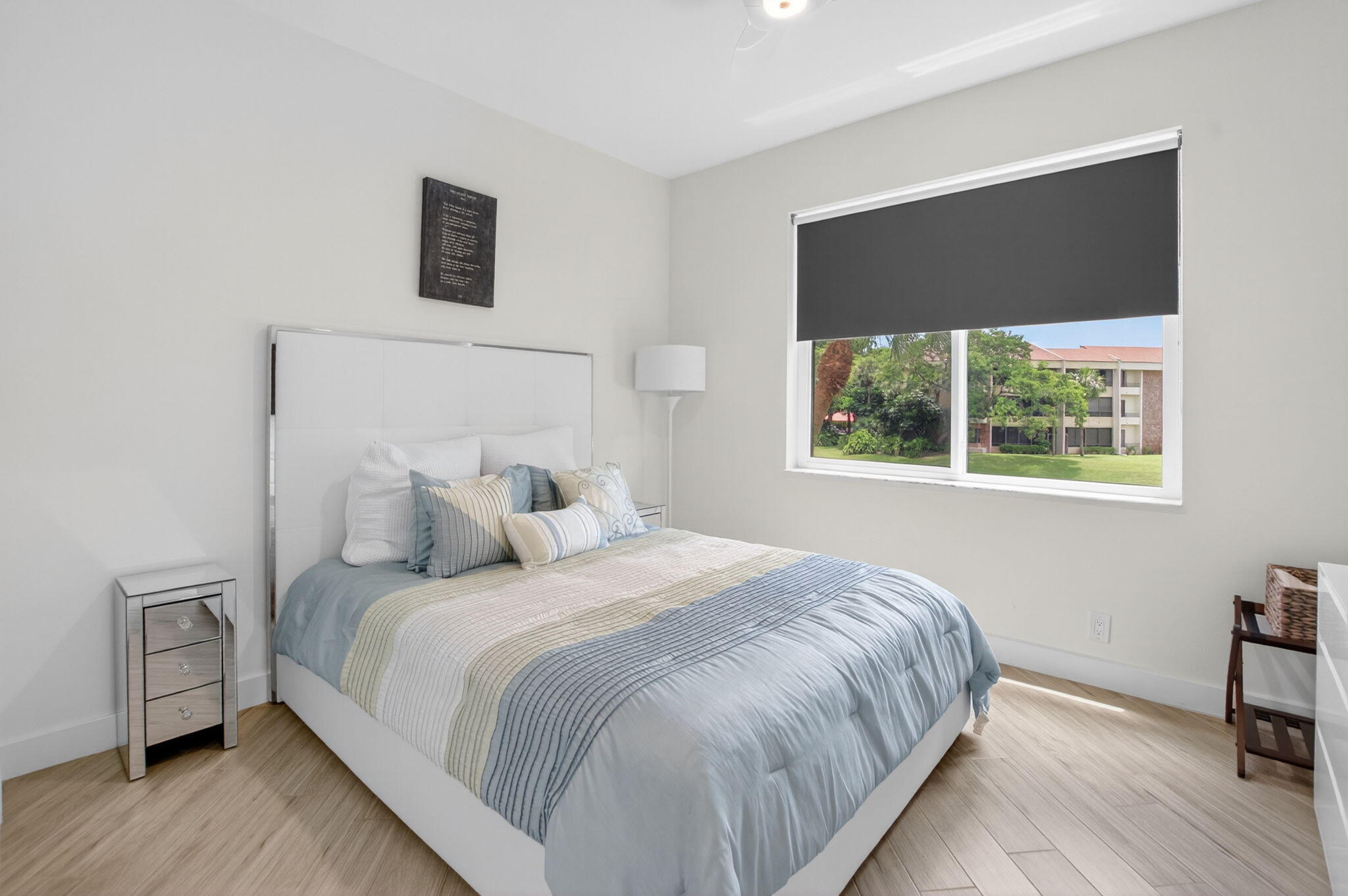 7546 La Paz Boulevard, Unit 205 Boca Raton, FL 33433 - Photo 19 of 33 a bedroom with a bed and a tv