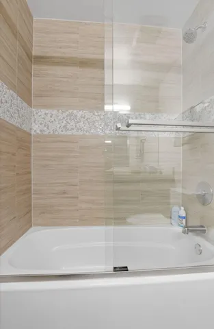 a bathroom with a bathtub and a shower