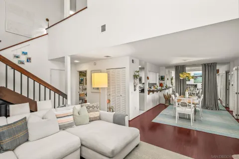 a living room with furniture and a table with wooden floor