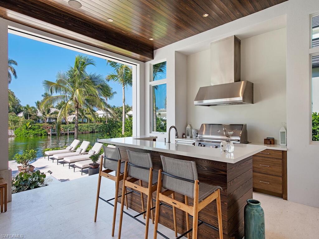 3320 Rum Row Naples, FL 34102 - Photo 11 of 39 a dining room with a table and chairs