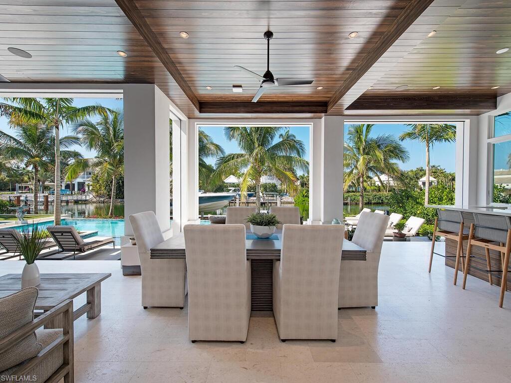 3320 Rum Row Naples, FL 34102 - Photo 12 of 39 a dining room with furniture windows and outdoor view