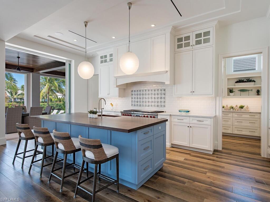 3320 Rum Row Naples, FL 34102 - Photo 15 of 39 a kitchen with sink cabinets and wooden floor