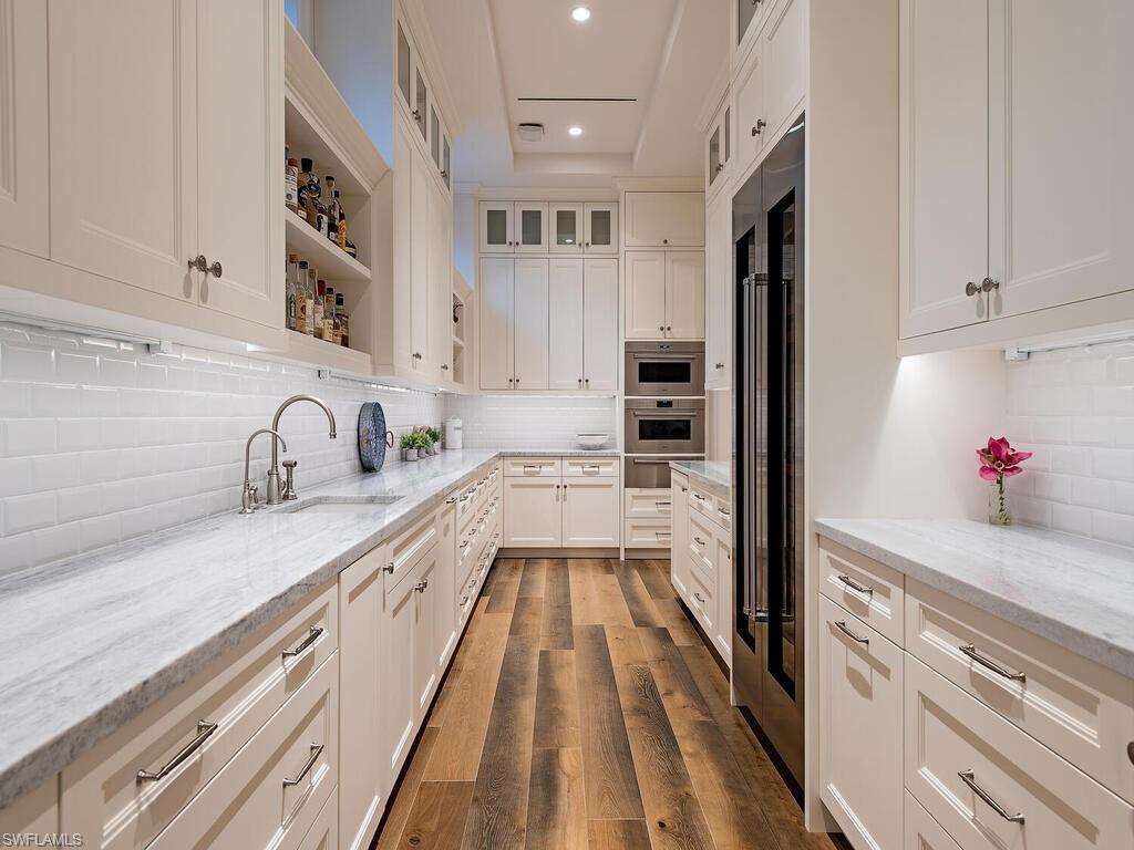 3320 Rum Row Naples, FL 34102 - Photo 17 of 39 a kitchen with kitchen island granite countertop a sink and appliances