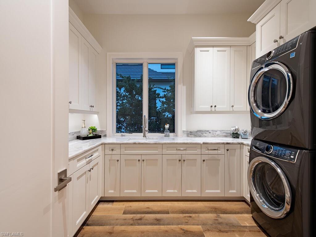 3320 Rum Row Naples, FL 34102 - Photo 19 of 39 a kitchen with a washer and dryer in it