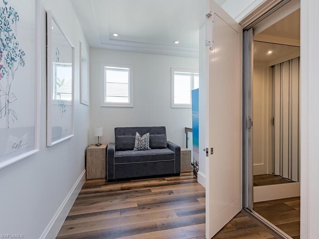 3320 Rum Row Naples, FL 34102 - Photo 20 of 39 a living room with furniture and a gate