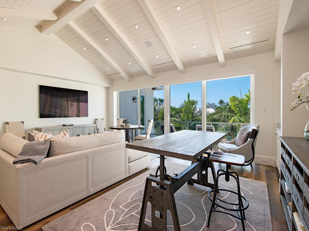 3320 Rum Row Naples, FL 34102 - Photo 21 of 39 a living room with furniture and a large window