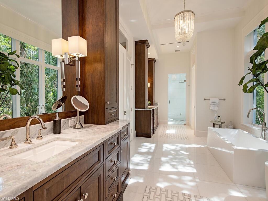 3320 Rum Row Naples, FL 34102 - Photo 24 of 39 a bathroom with double vanity sinks a vanity and a shower