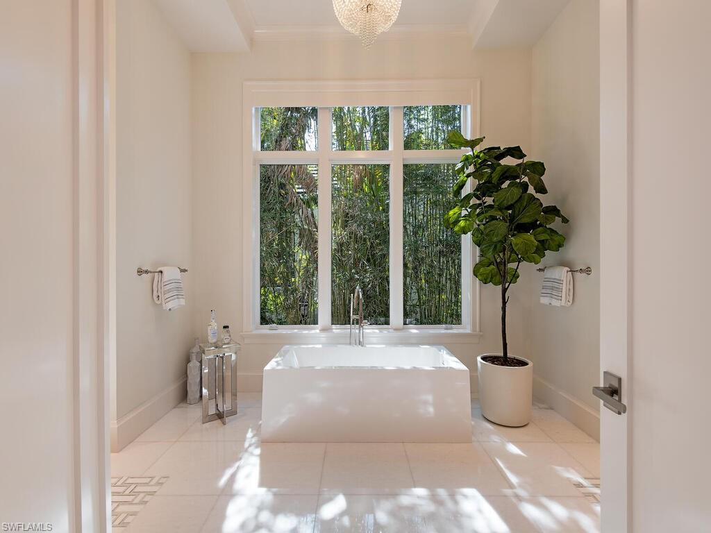 3320 Rum Row Naples, FL 34102 - Photo 25 of 39 a view of a potted plant in front of a door