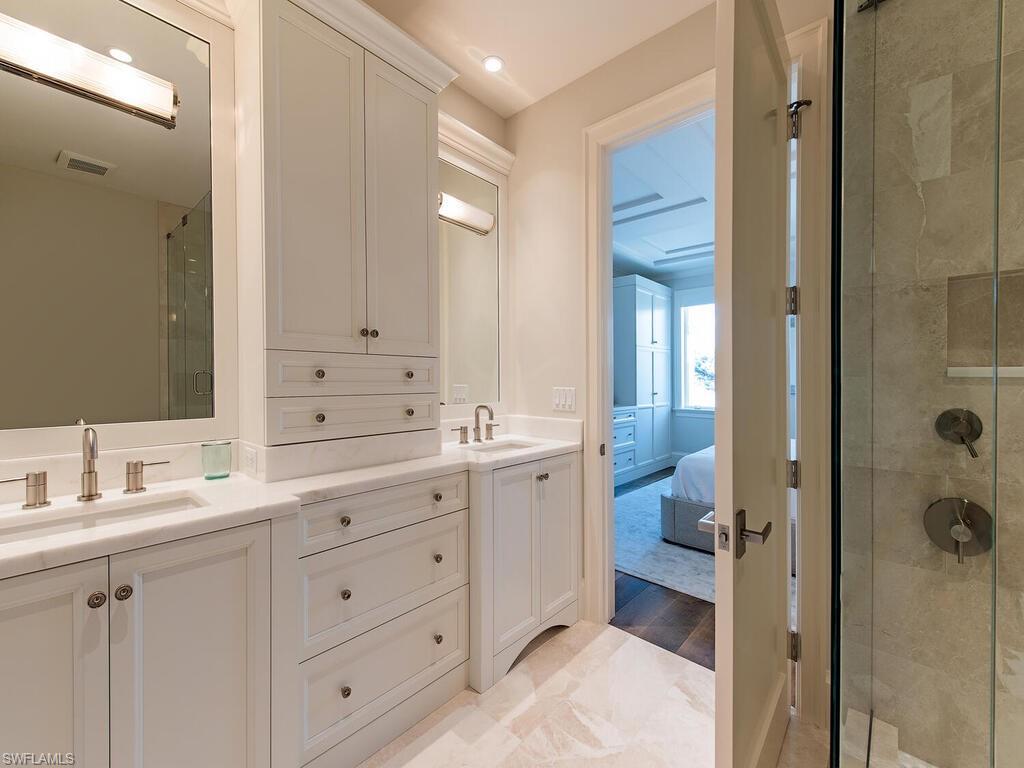 3320 Rum Row Naples, FL 34102 - Photo 28 of 39 a spacious bathroom with a double vanity sink a mirror and a shower