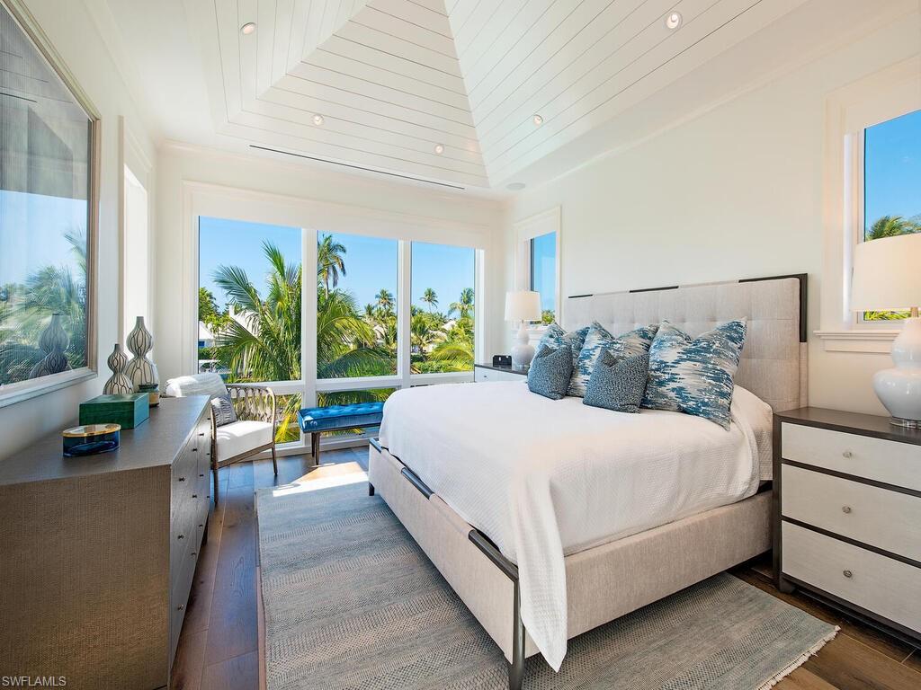 3320 Rum Row Naples, FL 34102 - Photo 29 of 39 a bedroom with a bed and large windows