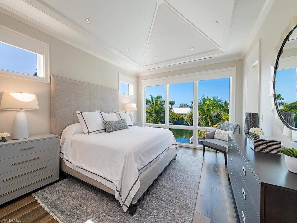 3320 Rum Row Naples, FL 34102 - Photo 33 of 39 a bed room with a bed and a large window