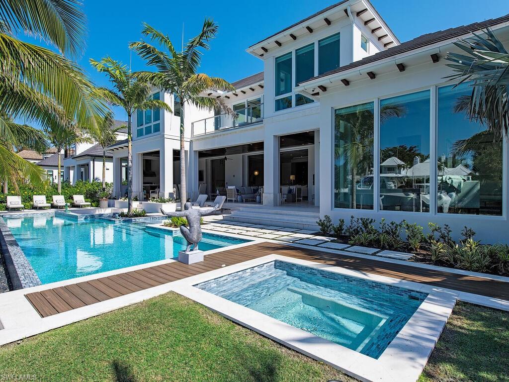 3320 Rum Row Naples, FL 34102 - Photo 9 of 39 a view of a house with pool and chairs