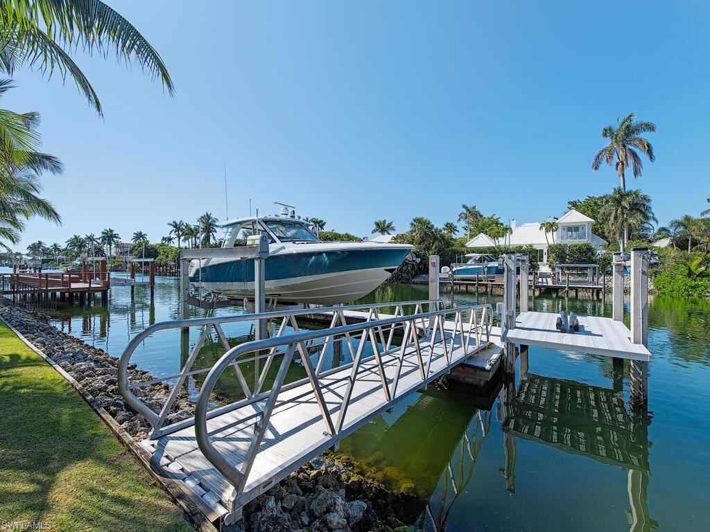 3320 Rum Row Naples, FL 34102 - Photo 10 of 39 a view of a swimming pool with chairs