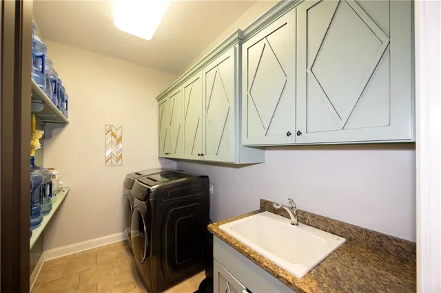 a utility room with a sink a washer and dryer