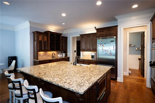 a kitchen with sink and refrigerator