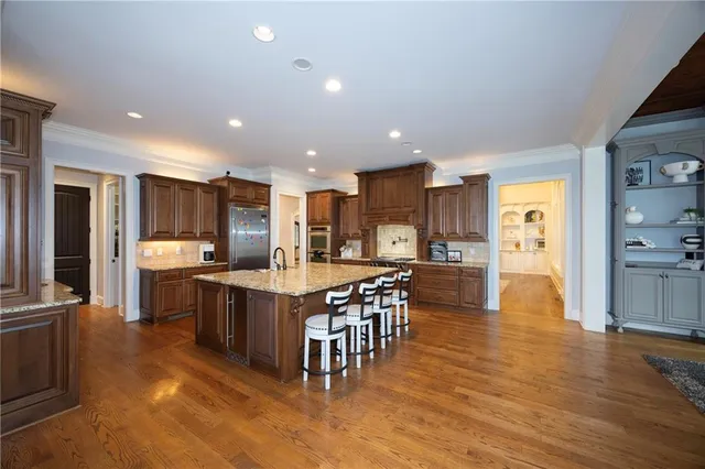 a large kitchen with stainless steel appliances lots of counter space and breakfast area