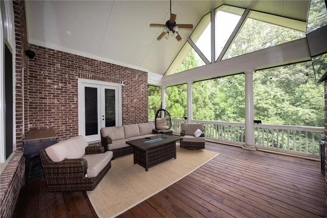 a living room with furniture and a floor to ceiling window