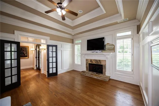 a view of a livingroom with a fireplace wooden floor and window