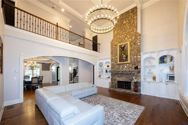 a view of living room with furniture and a fireplace