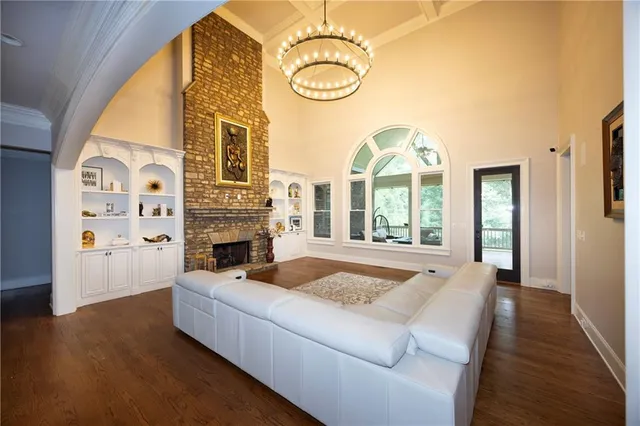 a living room with fireplace furniture and a large window