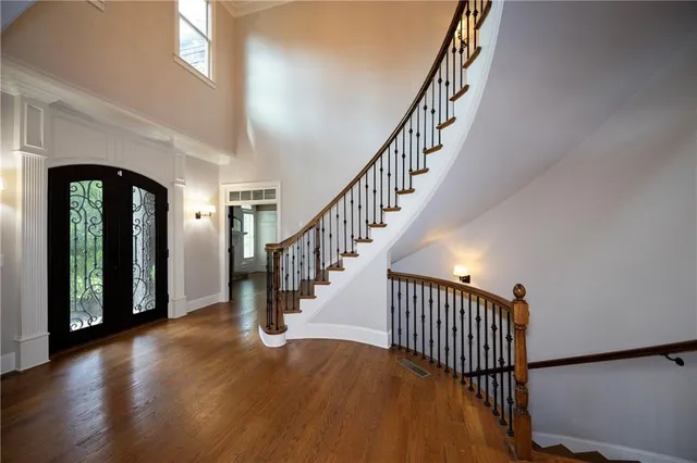 a view of staircase with wooden floor and a window