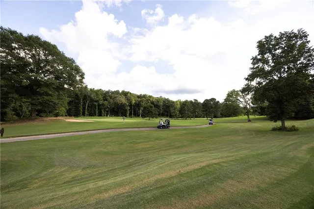 a view of field with trees in the background