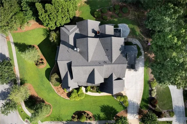 an aerial view of a house with a garden and swimming pool