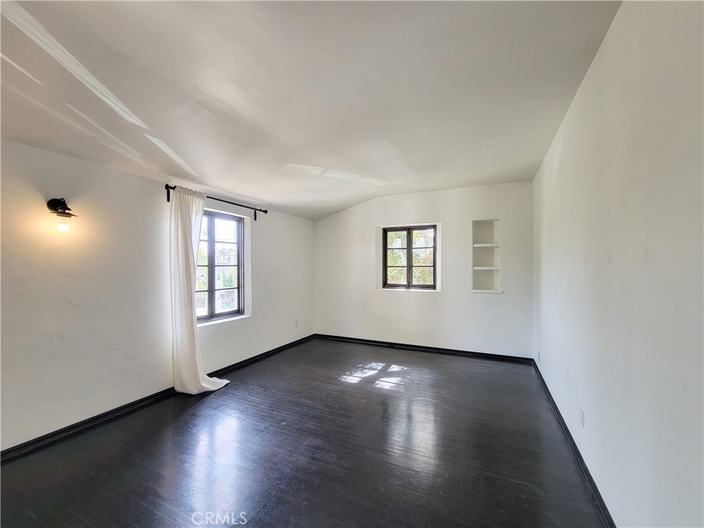 603 Termino Avenue Long Beach, CA 90814 - Photo 12 of 21 an empty room with wooden floor and windows