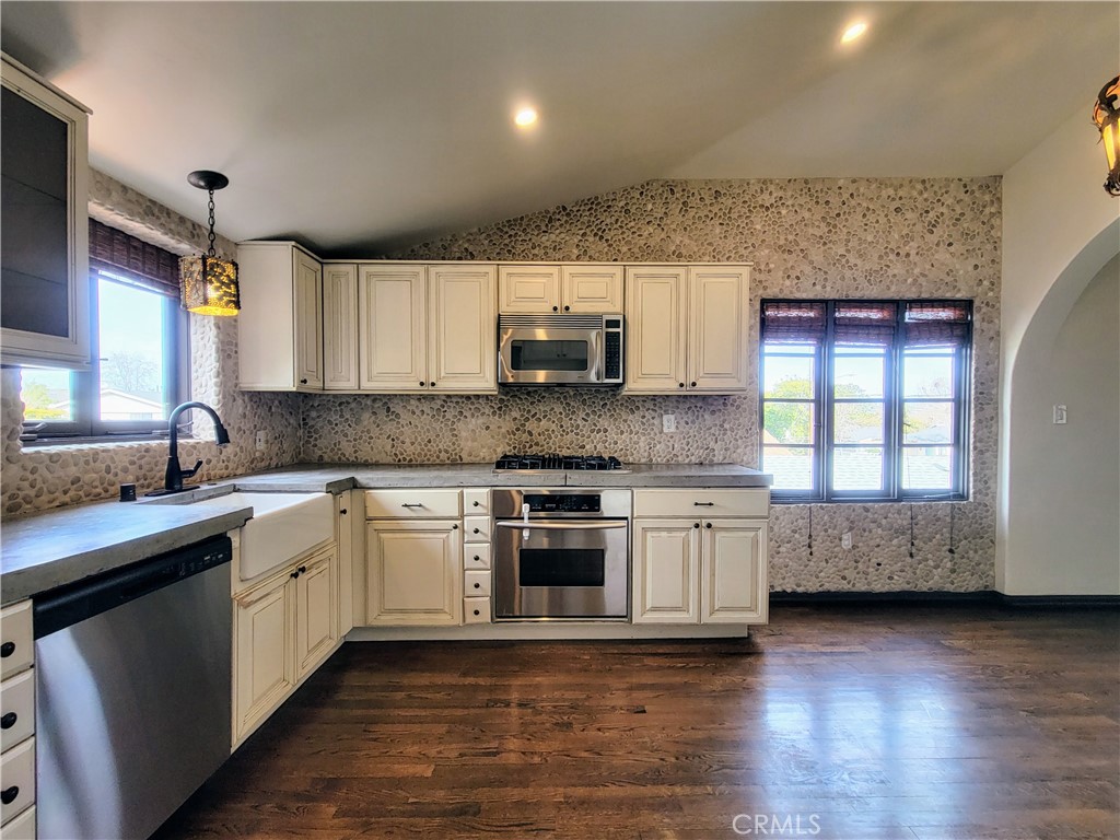 603 Termino Avenue Long Beach, CA 90814 - Photo 9 of 21 a kitchen with stainless steel appliances granite countertop a stove a sink and a microwave