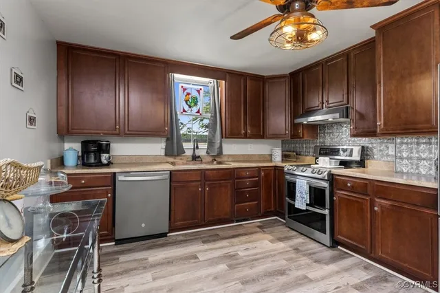 a kitchen with a cabinets a stove and a sink