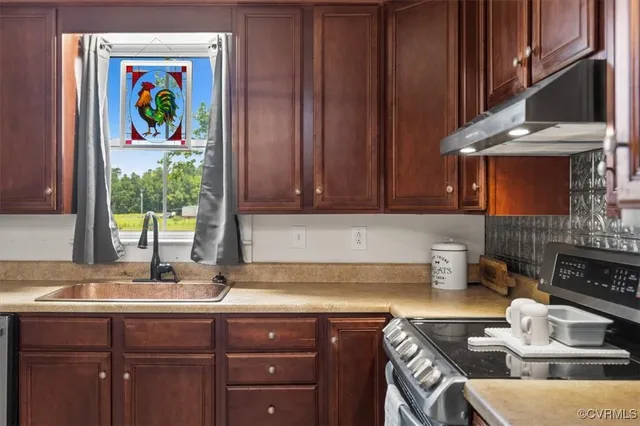 a kitchen with kitchen island granite countertop wooden cabinets stainless steel appliances and a sink