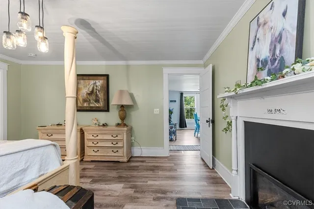 a spacious bedroom with a bed and wooden floor