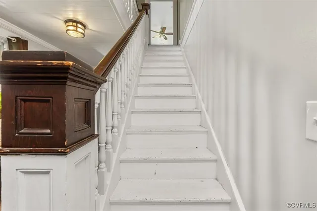 a view of a hallway to a livingroom with furniture
