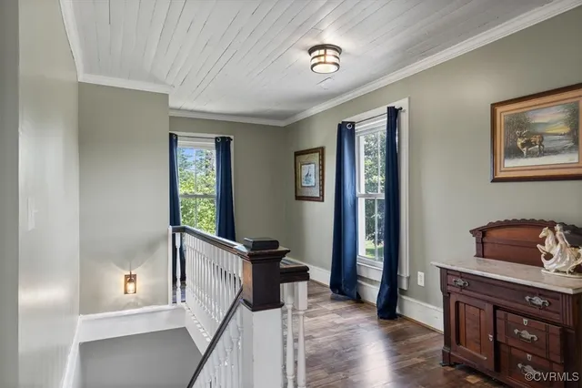 a view of a hallway with wooden floor and staircase