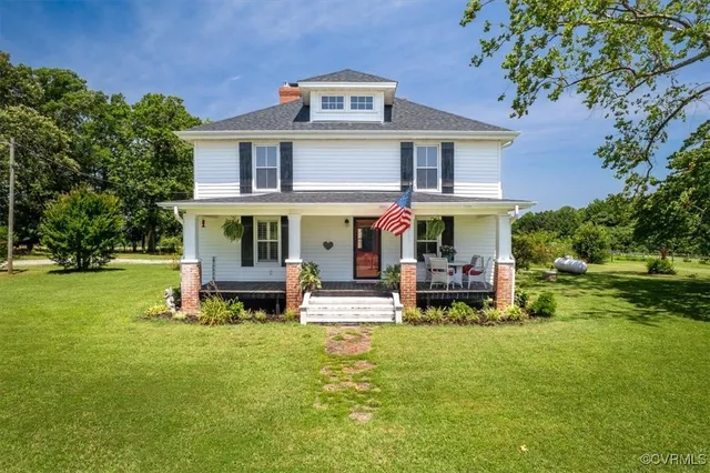 a view of a house with a yard porch and sitting area