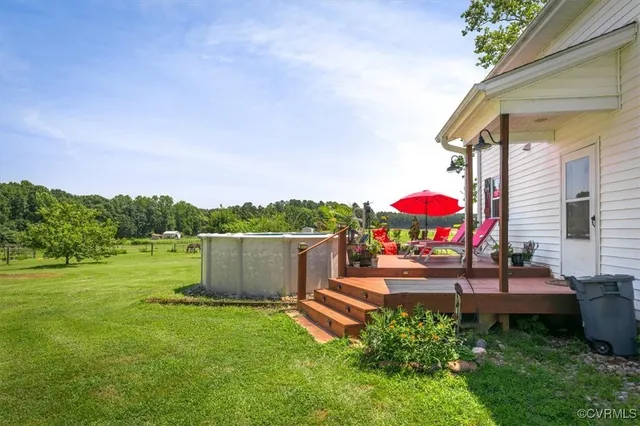 a backyard of a house with a yard and outdoor seating