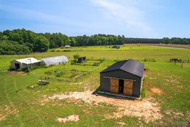 a view of a big yard with an ocean view