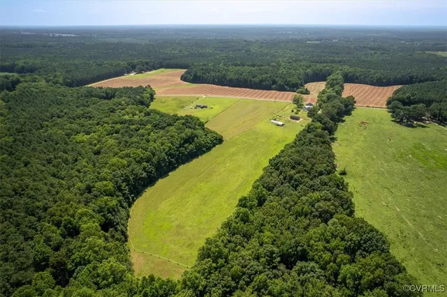 an aerial view of ocean with residential house