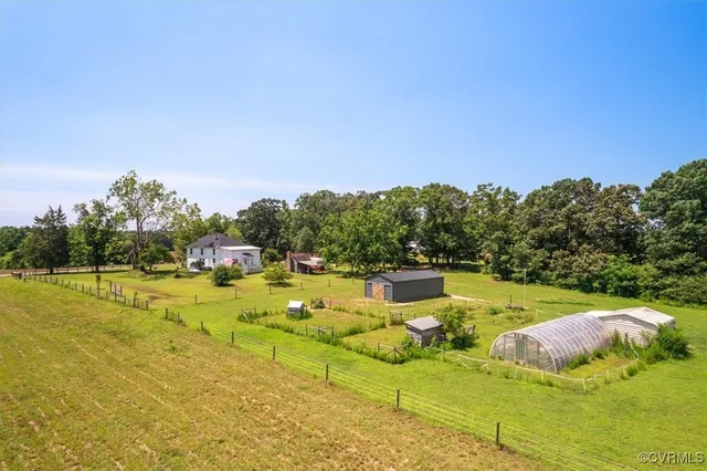 a garden with trees in front of it
