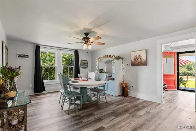 a view of a dining room with furniture and wooden floor